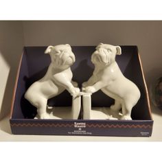 two figurines in a box on a table