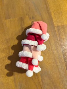 a red and white hat on top of a wooden floor