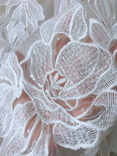 an image of white lace with flowers on it