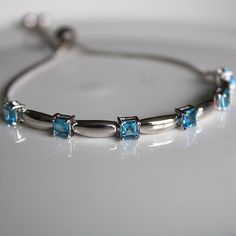 This sterling silver 3 mm Swiss Blue Topaz Gemstone Bolo Bracelet is simply elegant. She'll love the versatility this bracelet offers as it pairs amazingly with fine fashion and casual wear. The bracelet is comfortable and easy to adjust to your liking with the pull tie and ball clasp. A thoughtful gift for a December Birthday and a variety of other occasions and events. Explore All Of Our Timeless Jewelry: https://www.etsy.com/shop/JOHNWESHDESIGNS All JohnWeshDesigns jewelry is handcrafted and Cheap Blue Sterling Silver Bracelet, Elegant Adjustable Sterling Silver Birthstone Bracelet, Blue Birthstone Bracelets In Fine Jewelry Style, Blue Birthstone Bracelets Fine Jewelry, Adjustable Fine Jewelry Bracelets With Stones, Fine Jewelry Bracelets With Stones, Elegant Adjustable Blue Topaz Bracelets, Blue Sterling Silver Gemstone Crystal Bracelet, Anniversary Sterling Silver Gemstone Crystal Bracelet