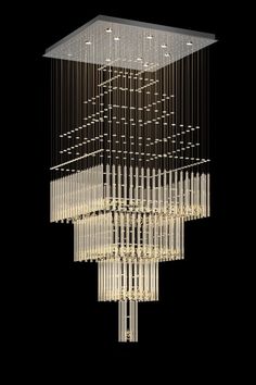 a large chandelier with many lights hanging from it's sides on a black background