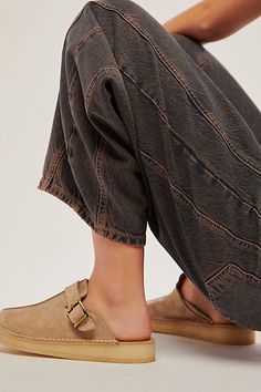 So cool and casual, these easy slip-on mules from Clarks feature a sleek suede upper with a dangling fringe detail and an attached logo fob. **Features:** Slip-on style, backless design, suede uppers, round toe, center seam, natural crepe rubber sole, pin buckle accents, tassel and fob accents **Why We | Clarks Trek Mules at Free People in Tan, Size: US 7 Train Trip, Suede Mules, Clarks Women's, Backless Design, Womens Mules, Clothing Styles, Mens Clothing, Fashion Flats, Get Dressed