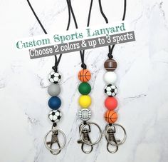 Wear your keys around your neck and support your team with this customizable sports lanyard! ◾Choose 2 colors and up to 3 sports! ◾ Made with food grade silicone beads, black satin/nylon cording, black break away clasp and silver lobster clasp and keyring ◾ Beaded section is 2.5 - 3 inches long ◾ Lanyard is standard length, approximately 20 inches long from the top of the break away clasp to the end of the silver lobster clasp. ◾ Hits right above the bellybutton, but you can easily shorten it. ◾ Adjustable Black Lanyards For School, Adjustable Black Lanyard For School, Customizable Adjustable White Lanyards, Customizable White Lanyards, Deep Royal Blue, Sports Coach, Lanyard Keychain, Diy Keychain, Cute Necklace