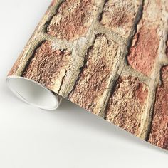 a close up of a brick wallpaper design on a white surface with a light colored background