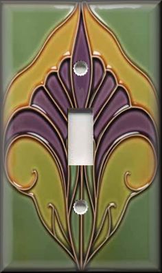 a decorative light switch plate cover in green and yellow with an art nouveau flower design