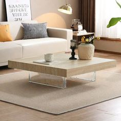 a living room with a white couch and coffee table