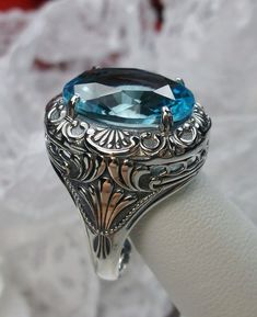 Simulated Aquamarine Ring Description Lion Design#218 MADE TO ORDER I now offer this is a brand new Art Deco/Victorian reproduction ring in solid sterling silver. The gorgeous filigree ring is set with a simulated Aquamarine. The high-quality round cut Aquamarine is 16mm by 12mm. The inside of the band is marked 925 for sterling. Notice the beautiful craftsmanship of the silver filigree setting. Feel free to ask questions and thanks for looking at my auctions. All rings can be sized by any jewel Formal Oval Gemstone Engraved Ring, Formal Oval Engraved Ring With Gemstone, Oval Gemstone Engraved Ring For Formal Occasions, Victorian Oval Engraved Ring With Intaglio, Victorian Oval Intaglio Engraved Ring, Victorian Oval Sapphire Ring, Exquisite Oval Engraved Jewelry, Exquisite Oval Filigree Jewelry, Victorian Style Oval Sapphire Ring