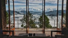 an open window overlooking the mountains and clouds