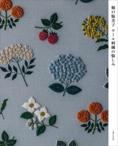 various flowers and leaves are embroidered onto the blue fabric with green leaves on each side