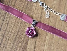 "Pink-purple velvet ribbon choker with sculpted handmade rose. Material of flower is polymer clay with special pearl cover. Each petal of flower made by hand Dia flower about 15 mm/ 0.55 \" Length of necklace is adjustable:  10-12 inches/ 25,4 - 30,5 cm 11-13 inches/ 28-33 cm 12-14 inches/ 30.5- 35.5 cm 13-15 inches/ 33-38 cm 14-16 inches/ 35.5 cm-40.5 cm 15-17 inches/ 38,1 cm- 43,2 cm 16-18 inches/ 40.6 cm- 45.7 cm 17-19 inches/ 43 cm - 48 cm 18-20 inches/ 45,5- 50.8 cm Width of ribbon 10 mm / 0.4 inch If you need other length of necklace let me know and I will make it for you. Polymer clay isn't afraid of water, strong and non-toxic. Gorgeous gift for women and girls as handmade item ALL CHOKERS - https://www.etsy.com/shop/BuduartJewelry?ref=simple-shop-header-name&listing_id=694544029§i Floral Choker With Flower Charm As A Gift, Flower Charm Choker As A Gift, Flower Shaped Choker With Flower Charm As Gift, Gift Rose Design Choker In Rose Color, Adjustable Rose Design Choker Necklace, Rose Design Choker As Gift, Purple Choker Necklace For Gift, Adjustable Flower Pendant Choker For Gift, Adjustable Flower Pendant Choker Gift