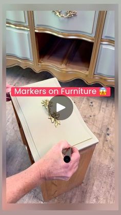 a person holding a pen in front of a dresser with the words makers on furniture