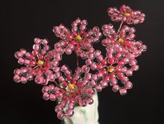 a vase filled with pink and yellow flowers