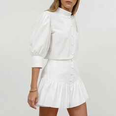 This Women's Summer Cotton Linen White Mandarin Collar 3/4 Sleeve Blouse and High Waist Tight Skirt Set is made from 100% cotton, ensuring softness, comfort, and skin-friendliness. The simple white Mandarin collar blouse pairs perfectly with the high-waisted tight skirt, featuring a playful pleated hem that adds a touch of fashion and charm. This set is ideal for daily wear, commuting, festivals, Valentine's Day, and weddings, offering a perfect blend of elegance and style. Chic Stretch Cotton Mini Skirt, Cotton Stretch Mini Skirt For Fall, Stretch Cotton Mini Skirt For Fall, Fitted Cotton Mini Skirt For Summer, Chic Fitted Mini Skirt For Daywear, Stretch Cotton Mini Skirt For Work, Fitted Cotton Chic Mini Skirt, Chic Fitted Cotton Mini Skirt, Fitted Cotton Mini Skirt For Fall