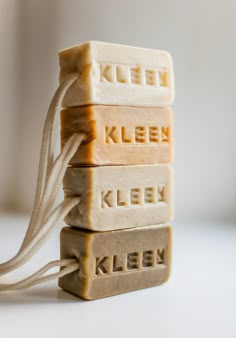 four soap bars stacked on top of each other with the words kleen written on them