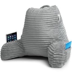 an elephant shaped pillow with a cell phone in it