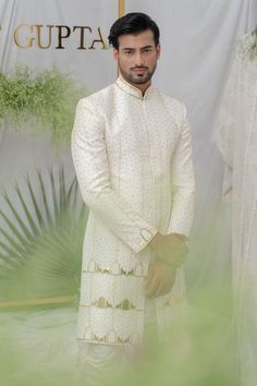 Ivory chanderi silk sherwani with gold acrylic elephant, khidki motifs and pipe embellishment. Paired with kurta and pant pyjama.
Components:3
Pattern:Embellished
Type of Work:Elephant, khidki, pipe
Neckline:Mandarin collar
Sleeve Type:Full sleeves
Fabric:Chanderi Silk, Cotton
Color:Ivory
Other Details:
Front button placket
Occasion:Destination Wedding - Aza Fashions Gold Raw Silk Sherwani With Cutdana, Festive Off-white Raw Silk Sherwani, Ceremonial Gold Kurta With Naqshi Details, Ceremonial Gold Kurta With Naqshi, Off White Straight Kurta Sherwani For Festive Occasion, Festive Off White Sherwani With Straight Kurta, Festive Off-white Sherwani With Straight Kurta, Off White Naqshi Bandhgala For Festive Occasions, Off White Bandhgala With Naqshi For Festive Occasions