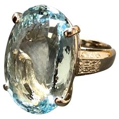 an oval blue topazte ring with two tone gold trimmings and diamond accents