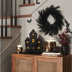 a halloween scene with candles and decorations on a table in front of the staircases