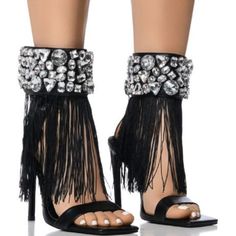 The Azalea Wang " The Rhinestone Draped Tassel Sandal " In Black Is An Open Square Toe Sandal Featuring A Faux Leather Upper, A Cushioned Faux Leather Midsole, A Slim Toe Band, And A Stiletto Heel. Complete With A Wide Rhinestone Gemstone-Embellished Ankle Band, Tassel Fringe Detailing, And An Easy-Open Velcro Closure. Accent This Pair With A Silky Slip Dress For A Luxe Look. - Open Square Toe - Stiletto Heel - Faux Leather Upper - 4.75” Heel Height Party Tassel Open Toe Heels, Party Heels With Tassels And Open Toe, Party Open Toe Heels With Tassels, Party Open Toe Sandals With Tassels, Party Sandals With Tassels And Open Toe, Party Heels With Fringe And Open Toe, Party Fringe Open Toe Heels, Fringe Open Toe Party Heels, Fringe Open Toe Heels For Party