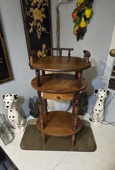 three tiered wooden shelf with dalmatian figurines on the floor next to it