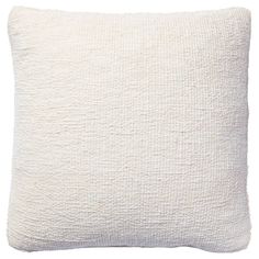 a white pillow that is made out of fabric and has a textured design on the front