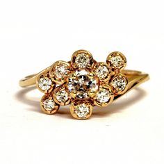 Exquisite 14 karat yellow gold cluster ring set to the center with a round-cut genuine diamond measuring approximately 4.28 millimeters in diameter and weighing an estimated .26 carats (SI1 clarity, G color), surrounded by 10 round-cut diamonds, each weighing .03 carats (VS1 clarity, G color), for a total carat weight for the ring of 0.56 carats. The ring is approximately 9.27 millimeters wide at the top and 2.29 millimeters wide at the shank. It weighs approximately 3.07 grams. It is a size 7, 14k Gold Cluster Diamond Ring With Prong Setting, Yellow Gold Diamond Cluster Ring For Anniversary, Yellow Gold Cluster Diamond Ring For Anniversary, Anniversary Yellow Gold Cluster Diamond Ring, Gold Cluster Diamond Ring In 14k, Cluster Yellow Gold Diamond Ring With Prong Setting, Yellow Gold Cluster Diamond Ring With Prong Setting, 14k Gold Cluster Ring With Prong Setting, Yellow Gold Diamond Ring With Brilliant Cut Cluster