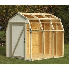 a small shed with the door open and windows on it's side, sitting in grass