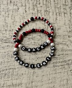 Let's Go Diamondbacks! 2 pack Arizona Diamondacks Friendship Bracelet for the AZ sports fan, Serpientes and D-Backs. Represent our National League Champions with two hand-crafted, beaded, stretch bracelets.  Great for Christmas gifts and stocking stuffers for teens.  All bracelets are standard women's size of approximatley 7 inches. Please message me if you would like bigger or smaller sizes. Custom orders are available for Diamondbacks Fans with different slogans or for specific players, Carroll, Marte, Thomas, Gallen. Please message me for custom orders.  Tips to care for your bracelets: * Always roll bracelets on rather than stretching * Do not get wet