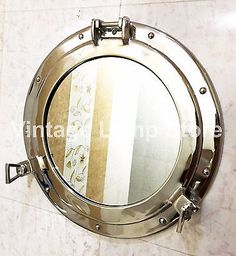 www.modelifurniture.com Working porthole which opens and closes. Finish :Nickel Silver Finish (As shown in Picture). Material :Aluminum and Mirror.