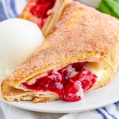 a crepe sandwich on a plate with ice cream and strawberry compote