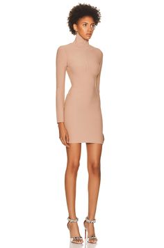 Find ALAÏA Angie Dress on Editorialist. The ALAÏA Angie Dress is a fitted dress made from matte viscose fabric. It features a high neck, long sleeves, and a partial front zip. The dress has a hidden side zip closure and is unlined. The dress is made in Italy. 72% viscose, 15% polyester, 12% polyamide, 1% polyurethane. Dry clean only. Fitted Long Sleeve Dress For Spring Formal, Fall Cocktail Bodycon Long Sleeve Dress, Knee-length Elastane Cocktail Dress, Fitted Evening Dresses For Fall, Fitted Fall Evening Dresses, Structured Bodycon Dress For Party, High Neck Fitted Mini Dress For Evening, Fitted High Neck Mini Dress For Evening, Structured Bodycon Party Dress