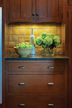 a bowl of broccoli sits on a kitchen counter