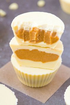 three cupcakes stacked on top of each other with frosting and peanut butter