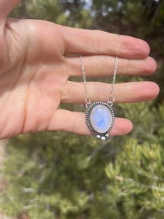 This pendant features a gorgeous blue flash Moonstone set in Sterling Silver with a beaded pattern and three larger dots in the center :) This is a beautiful flashy stone with lots of depth and an open-back design to allow lots of light to show off the crystal! The pendant comes as pictured on an 18" chain. Please let me know if you would prefer a shorter or longer length! Celestial Jewelry With Oval Natural Stones, Celestial Style Oval Jewelry With Natural Stones, Celestial Oval Jewelry With Natural Stones, Silver Celestial Jewelry With Oval Cabochon, Blue Moonstone Jewelry With Stones, Round Moonstone Jewelry With Stones, Bohemian Moonstone Jewelry With Large Stone, Bohemian Jewelry With Large Moonstone, Bohemian Moonstone Cabochon Jewelry