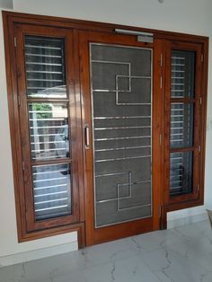 two wooden doors with blinds on them in front of a white wall and tiled floor