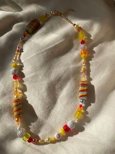 "★ The \"southern sunset\" necklace is bright, colorful, and perfect for summer ★Made with lamp-worked glass beads, acrylic pearls, seed beads and acrylic beads ★All necklaces come with a 2\" extension chain ★Please message me if you would like a different length" Summer Yellow Beaded Necklaces With Large Beads, Yellow Beaded Necklaces With Large Beads For Summer, Yellow Glass Beaded Necklace, Summer Glass Beaded Necklaces, Summer Necklaces With Dangling Round Beads, Tiny Yellow Beads For Summer, Summer Multicolor Beaded Necklaces With Dangling Beads, Yellow Necklaces With Colorful Beads For Summer, Yellow Round Bead Necklaces For Summer