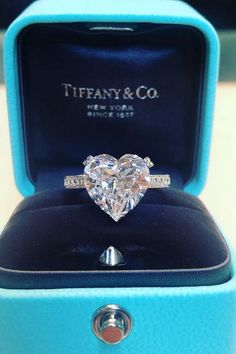 a heart - shaped diamond ring in a blue box with the tiffany & co logo on it