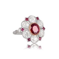 A lovely floral style ring featuring a 1.31ct natural oval ruby with 2.10 carats of diamonds encircling the center stone. Handcrafted in platinum, this ring also includes small square-cut rubies and fine milgrain to accent the edges of the halo. The center gem is bezel-set between old mine diamonds. Small rubies and fine milgrain encircle the diamond halo. ✦ GEM SPECIFICATIONS: Center Stone Weight: 1.31 Carats Total Diamond Weight: 2.10 Carats Center Stone Shape: oval-shape ✦ ENGAGEMENT RING SPE Luxury Oval Ruby Diamond Ring, Luxury Oval Ruby Birthstone Ring, Exquisite Oval Ruby Ring Gia Certified, Luxury Ruby Ring With Oval Center Stone, Luxury Oval Ruby Ring With Center Stone, Exquisite Oval Ruby Ring With Center Stone, Exquisite Oval Ruby Ring, Oval Ruby Ring With Platinum Center Stone, Oval Ruby Ring With Platinum Band