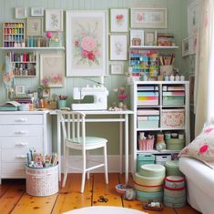 a sewing room with lots of crafting supplies on the desk and shelves above it