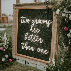 a chalkboard sign with the words two grooms are better than one written on it