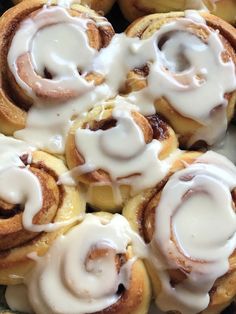 there are many cinnamon rolls with icing on them