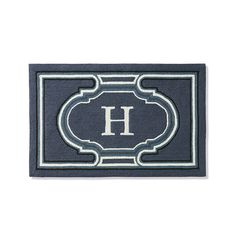 a blue door mat with the letter h on it and an ornate border around it