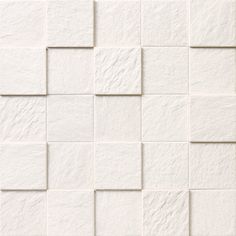 a white tile wall that has squares on it