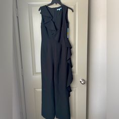 Women’s Antonio Melani Eva Ruffle Front Jumpsuit/Romper In Black Nwt! New With Tags, This Adorable Romper Has Never Been Worn, Has Stayed Inside A Garment Bag Since Purchase, And Comes From A Smoke And Pet-Free Home. It’s The Perfect Outfit For Any Occasion- Date Night, Dinner, Or Evening Wedding Guest. Color: 001 Midnight Waltz Size: Us 2 | Uk 6 | Europe 32 -Crepe Fabrication -V-Neckline -Sleeveless -Ruffle Trim Detail From Shoulder To Opposite Leg -Full Length, Straight Hemline -Invisible Back Sleeveless Ruffled Jumpsuits For Formal Occasions, Formal Sleeveless Ruffled Jumpsuits And Rompers, Formal Sleeveless Ruffled Jumpsuit, Fitted Black Jumpsuit With Ruffles, Fitted Ruffle Jumpsuits And Rompers For Work, Black Ruffled Jumpsuits And Rompers For Work, Fitted Ruffled Jumpsuits And Rompers For Work, Fitted Ruffles Jumpsuits And Rompers For Work, Formal Black Ruffled Jumpsuits And Rompers