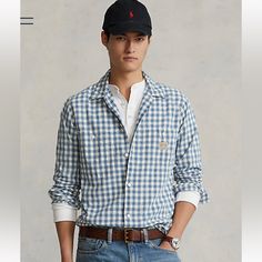 New With Tag Polo Ralph Lauren Classic Fit Gingham Workshirt Color: Blue/White Classic Fit: Our Roomiest Silhouette. Cut For A Lower Armhole And A Fuller Sleeve. Size Medium Has A 30.5" Back Body Length, An 18.25" Shoulder, A 46" Chest, And A 34.5" Sleeve Length. Sleeve Length Is Taken From The Center Back Of The Neck And Changes 1" Between Sizes. Spread Collar. Buttoned Placket. Long Sleeves With Buttoned Barrel Cuffs. Two Chest Buttoned Pockets. Pleated Back Yoke Ensures Smooth, Contoured Shou Casual Collared Gingham Shirt, Casual Gingham Collared Shirt, Collared Gingham Tops With Relaxed Fit, Preppy Plaid Cotton Top, Gingham Cotton Shirt For Work, Plaid Cotton Preppy Shirt, Preppy Plaid Cotton Shirt, Casual Gingham Tops For Work, Preppy Cotton Shirt