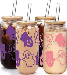 three jars filled with different types of drinks and straws on top of each jar