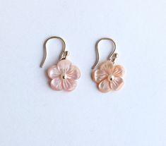 "These earrings are from our Flower Collection. Each piece in this collection features one or more hand-carved genuine stone flowers. Hand-sculpted from pink Mother of Pearl into beautiful floral blooms, the flowers measure 15mm and have white Fresh Water Pearls at their centers.  Earring Length: 1.13\" Closure: S Hook" Pink Flower Shaped Pierced Earrings, Feminine Flower Jewelry With 3d Flowers, Elegant Pink Jewelry With 3d Flowers, Wedding Flower Earrings In Mother Of Pearl, Feminine 3d Flower Jewelry, Rose Gold Flower Charm Earrings, Flower-shaped Mother Of Pearl Earrings For Wedding, Elegant Pink Flower Earrings In Sterling Silver, Rose Gold Round Flower Charm Earrings