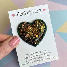 a heart shaped brooch sitting on top of a card