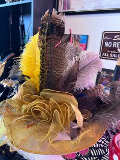 Ruffle burnt yellowish derby style hat one size adjustable. Handcrafted with marching big bow and multi color assorted style feathers Feathered Mini Hats For Kentucky Derby Festival, Derby Hat, Mesa Az, Big Bow, Derby Hats, Big Bows, Hat Fashion, Derby, Feathers