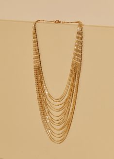 Chains on chains on chains!!! Shine bright all night into the morning wearing our gold-tone multichained necklace. Party Necklaces With Gold Snake Chain, Party Necklace With Gold Snake Chain, Multi-strand Delicate Chain Necklace For Party, Delicate Multi-strand Chain Necklace For Party, Gold Double Chain Necklace For Party, Party Gold Snake Chain Necklace, Gold Layered Snake Chain Necklace, Chunky Chain Layered Metal Necklace For Party, Gold Multi-strand Jewelry For Party